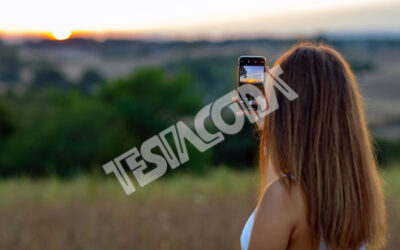 Young Girl taking photos of Sunset